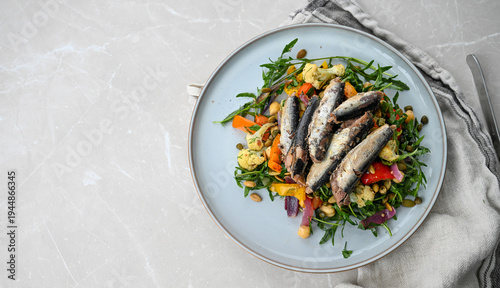 Close up of Greens and Roasted Vegetables Salad Topped with Canned Sardines for Omega-3 and Protein