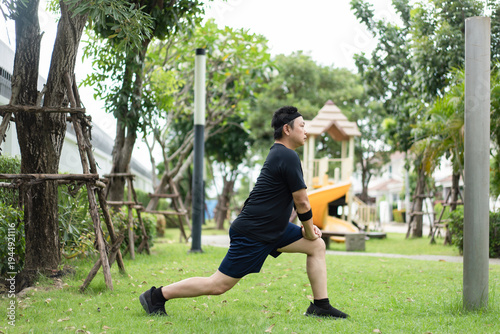 Photos A man performs a lunge stretch outdoors, extending his leg to stretch the hip flexors and quadriceps while improving flexibility and balance