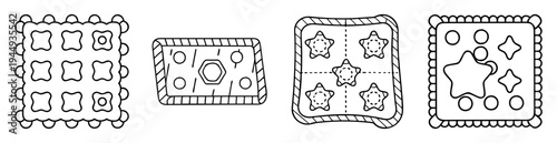 Collection of four distinct outlined square cookies with unique decorations