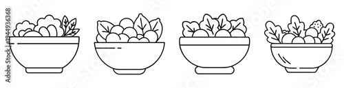 Black and white bowls filled with leafy vegetables and round ingredients