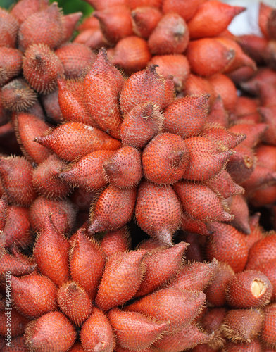 Close-up of fresh salak (snake fruit), a rare tropical Southeast Asian fruit with reddish-brown scaly skin, commonly sold in local markets and known for its sweet, crisp taste.