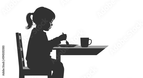 Silhouette of a little girl eating at a table with a plate and cup