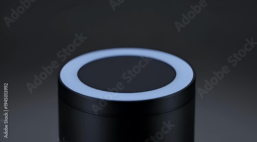 Close up of sleek black cylinder with blue illuminated ring at top