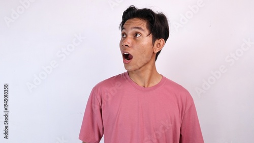 young asian man with surprised expression looking to the side