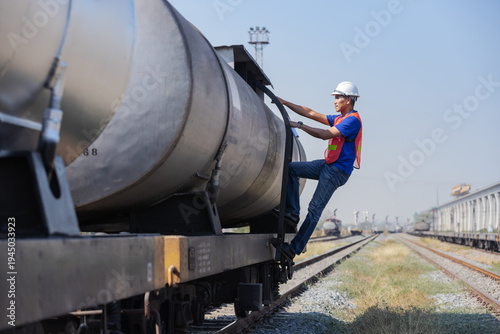 Railway Technician Inspecting Oil Tanker Wagon on Freight Train