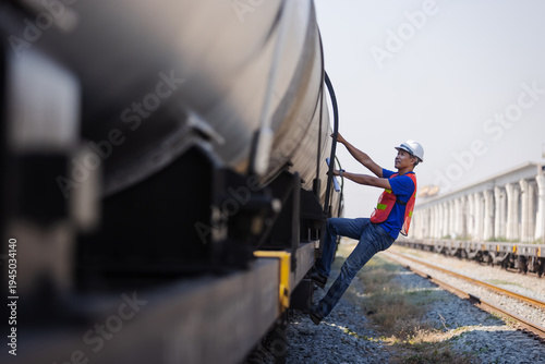 Railway Worker Climbing Freight Tanker for Safety Inspection