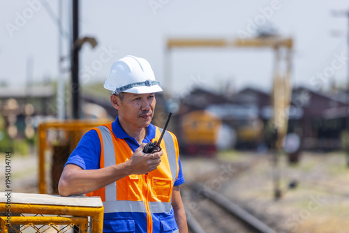 Fotografija Railway Worker Using Radio Communication at Train Station