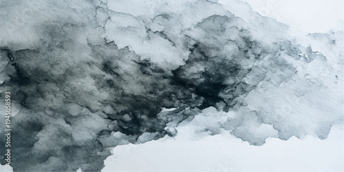 A breathtaking aerial view of snow-covered mountains rises into a crisp blue sky filled with fluffy white cumulus clouds during a cold winter day