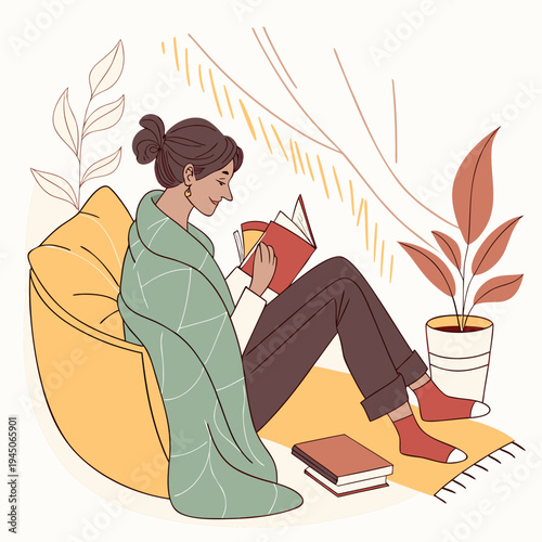 Woman sitting in bean bag chair reading book relaxing