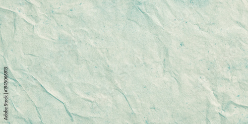 Neutral toned background featuring a light beige or blue surface with realistic crumpled paper textures with a soft stains, making it ideal for minimalist branding.	