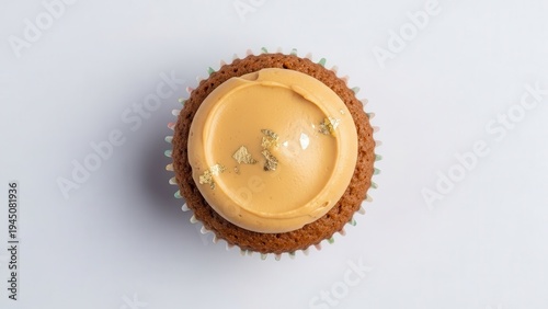 A cupcake with caramel frosting on a white background