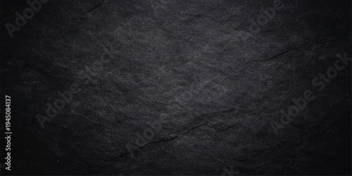 A dark grunge paper texture with a rough black and white vintage pattern on a weathered grey surface for a blank wallpaper backdrop
