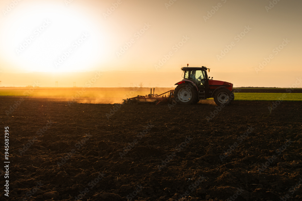 Fototapeta premium Tractor preparing the land for a new crop planting
