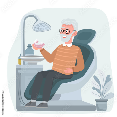 Senior man sitting in a dental chair and holding a removable denture in a dental clinic. Concept of prosthetic dentistry, tooth replacement, oral health care for elderly patients
