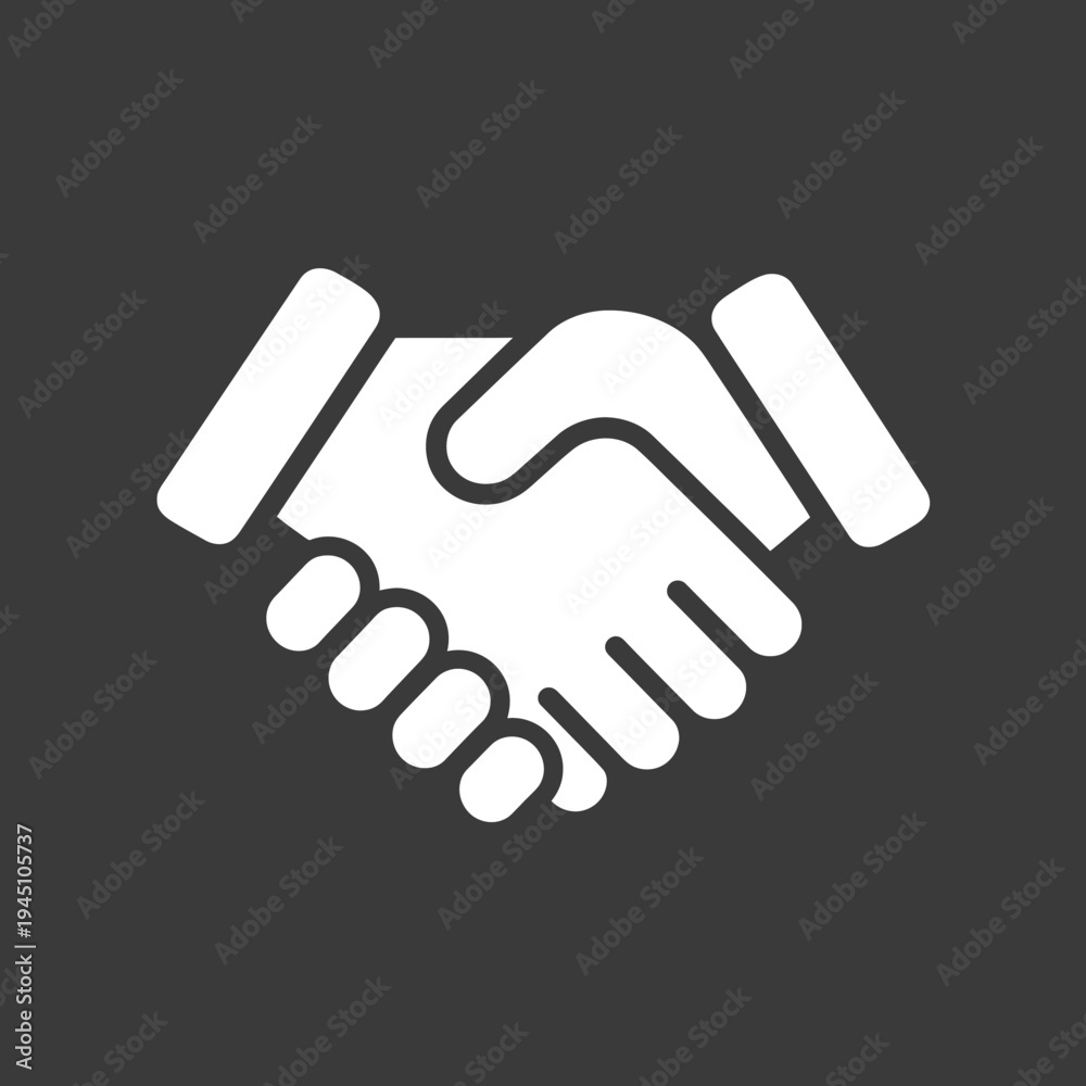Fototapeta premium Two white hands shaking on a dark background showing agreement and collaboration