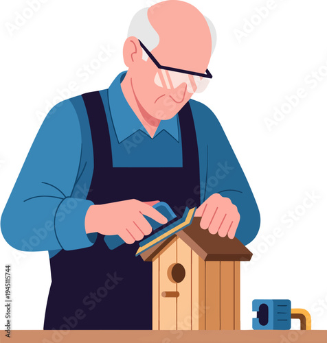 Elderly man wearing safety glasses and apron sanding a wooden birdhouse.