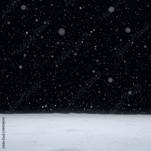 Snowflakes settle on the ground in a vast expanse of black, peaceful, cold