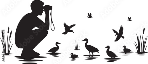 Man photographing ducks and birds in water with reeds