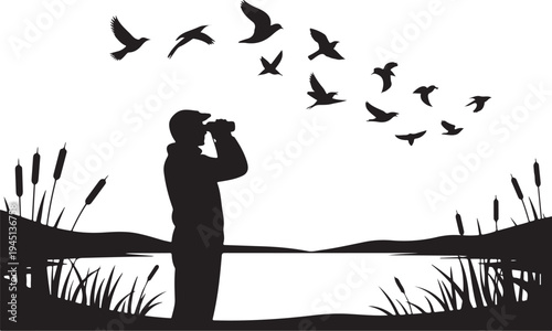 Man using binoculars looking at flying birds over lake with cattails