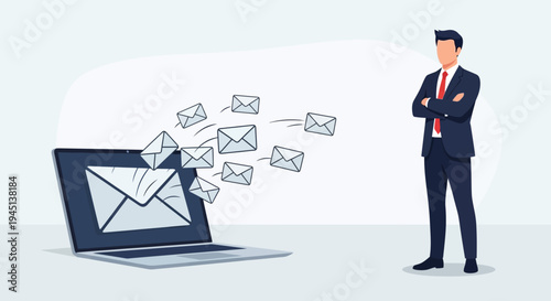 Businessman standing with laptop sending emails.