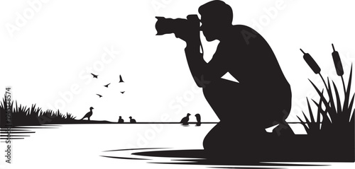 Silhouette of photographer taking of birds by lake