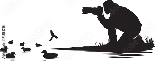 Silhouette of photographer taking of ducks in water