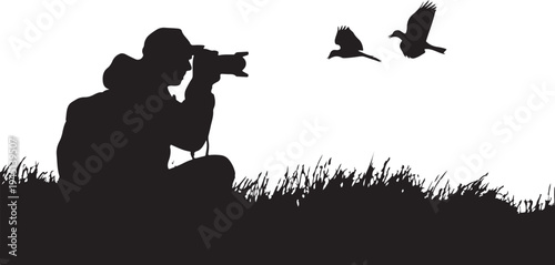Silhouette of photographer taking of flying ducks camera
