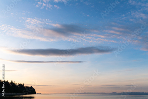 Canada, BC, Denman Island.  Benign clouds over the Strait of Georgia at sunset.