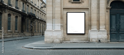 Blank billboard on a stone building facade next to street