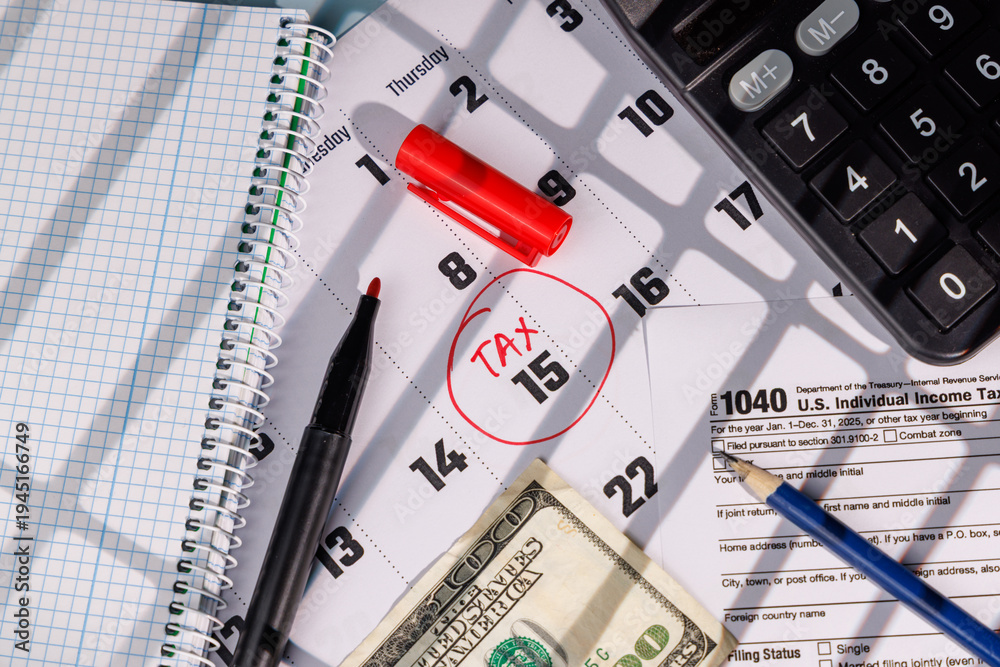 Fototapeta premium US Tax Day April 15 marked on a calendar with a red circle near IRS Form 1040 and a hundred dollar bill for business finance ads.
