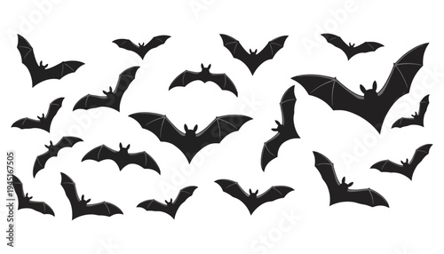 A flock of black bat silhouettes flying in various directions