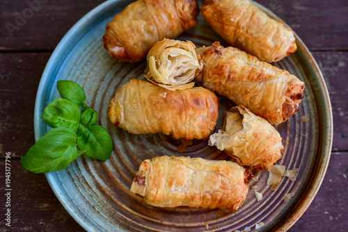  Greek style Mini filo pastry rolls with bacon and cheddar cheese .Home made bakery .Fresh baked  Mini cheese  ,meat and herbs puff pastries