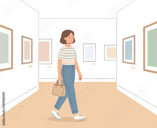 A woman walks through an art gallery viewing various framed artworks on display.