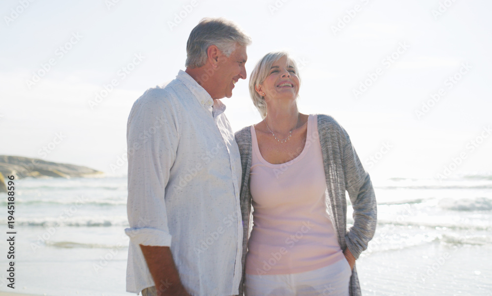 Fototapeta premium Vacation, couple and relax with laugh at beach for romantic getaway, funny chat and bonding. Holiday, mature people and talking at seaside with weekend break, healthy relationship and humor on space