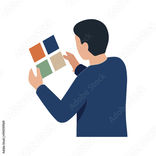 Man holding and examining color swatches in hand closely