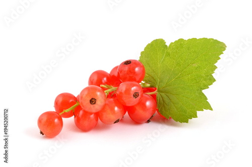 Sweet red currants with leaves on white backgrounds.