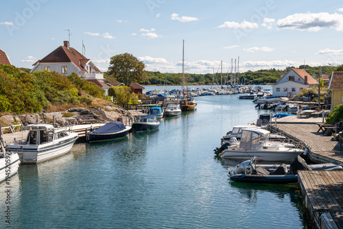 Small boats moored along harbour channel in Grundsund marina, Skaftö island, Bohuslän archipelago, west coast of Sweden