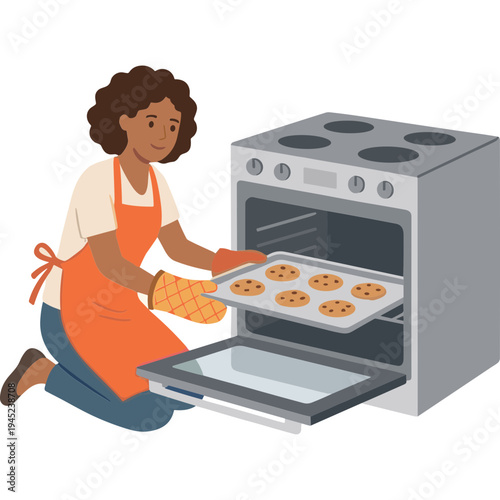 Woman taking cookies out of oven with tray in kitchen