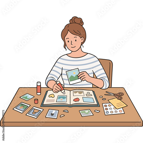 A woman sitting at a desk, cutting a photo and arranging pictures in a scrapbook with scissors and glue.