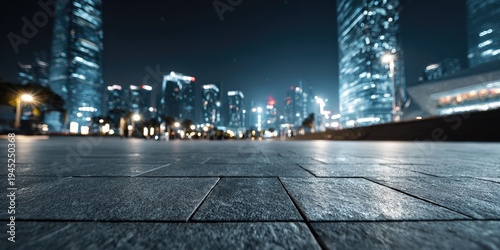 Nighttime cityscape with glowing skyscrapers and paved ground