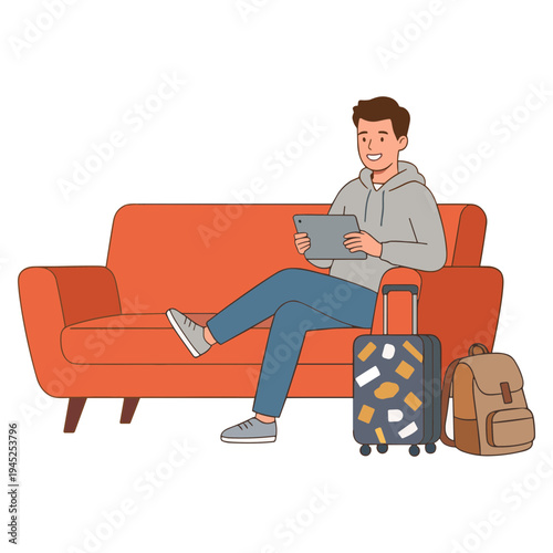 Man sits on couch with tablet and luggage nearby smiling