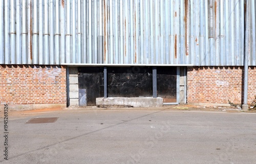 Wallpaper Mural Barred entrance gate with brick wall by sides and a large metal panel on it to prevent the wall from being climbed over. Grunge background for copy space. Torontodigital.ca