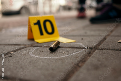 Bullet casing marked as evidence at crime scene