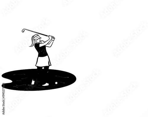 Woman golfer in water hazard, swings club with focus