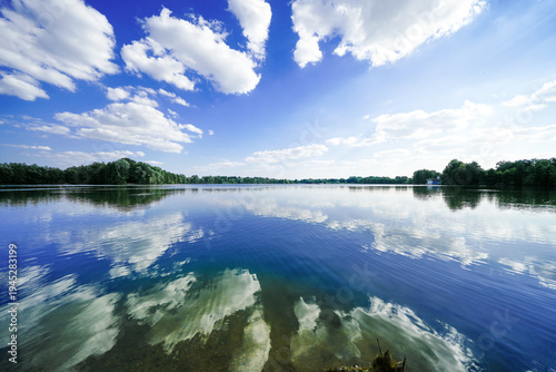 View of Lake Mastholte and the surrounding green landscape. Nature by the lake near Rietberg in the Gütersloh district.
