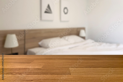 Empty old wood table in front of blurred beautiful bedroom looks clean and decorated in comfortable tones, suitable for relaxation. Can be used for display or montage for show your products.