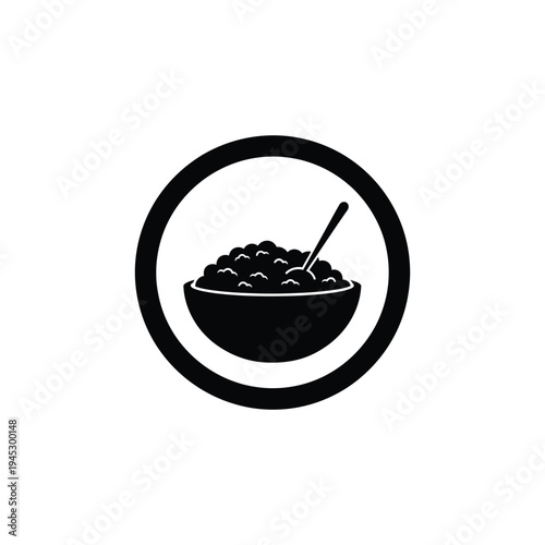 A bowl of food with a spoon is served in a circular frame.