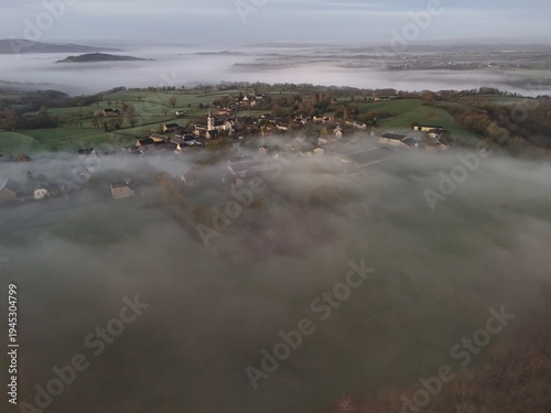 French village countryside sunrise in morning fog - Arial drone view