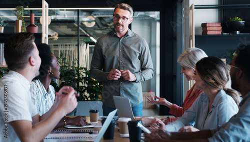 Tableau sur toile Creative, team and man with meeting in office for editorial guidance, writing advice and feedback