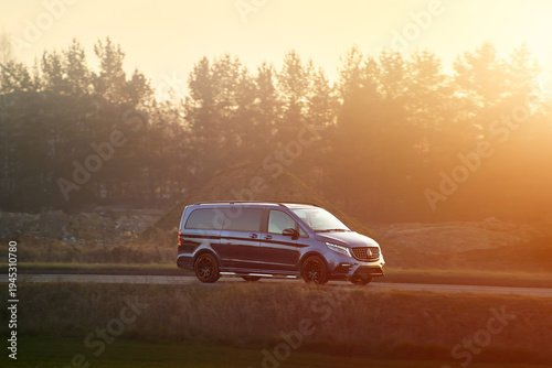Quadro su tela Passenger minivan on busy asphalt road